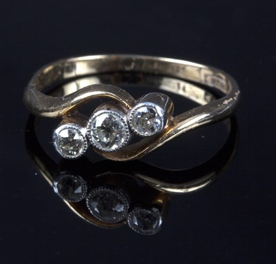 Lot 222 - A diamond three-stone ring in an 18ct yellow...