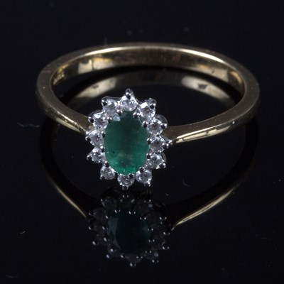 Lot 224 - An emerald and diamond oval cluster ring, set...