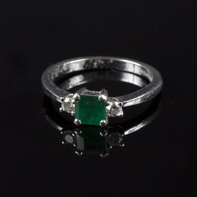 Lot 225 - An emerald and diamond three-stone ring, the...