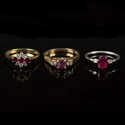 Lot 226 - A ruby and diamond three-stone ring, the oval...