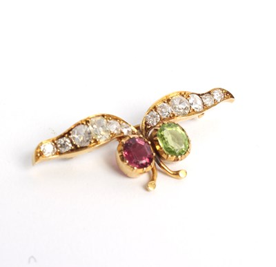 Lot 240 - A diamond and tourmaline brooch, of stylised...