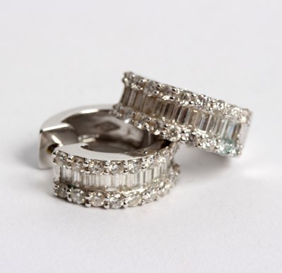 Lot 254 - A pair of diamond half-hoop earrings, each set...