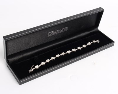 Lot 255 - A diamond line bracelet, set with sixty-five...