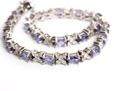 Lot 256 - A diamond and tanzanite bracelet, set with...