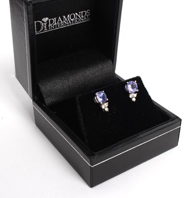 Lot 257 - A pair of diamond and tanzanite earrings, each...