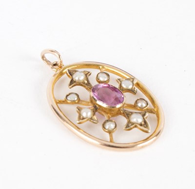 Lot 259 - A gem set 10K gold oval pendant, the central...