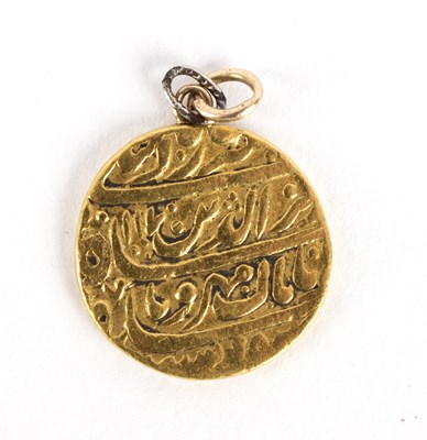 Lot 276 - A small Islamic gold pendant, script to both...