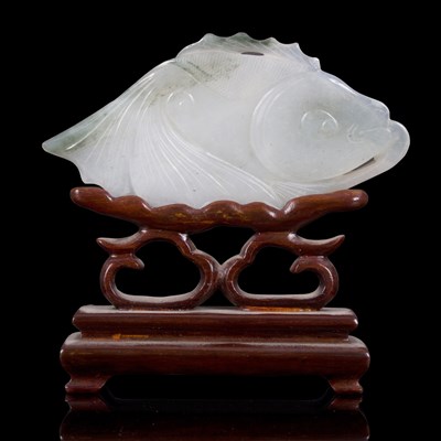 Lot 373 - A pale celadon carving of a carp swimming in...