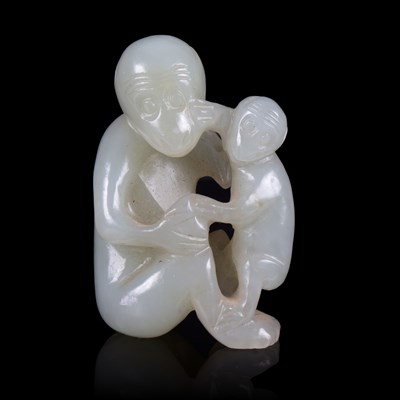 Lot 374 - A pale celadon jade carving of a monkey with...