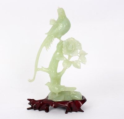 Lot 377 - A jade carving of birds in flowering branches,...