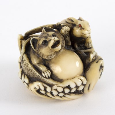 Lot 384 - A Japanese ivory netsuke, carved a badger and...