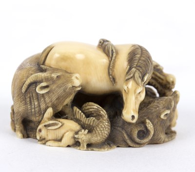 Lot 385 - A Japanese ivory netsuke, carved zodiac of...