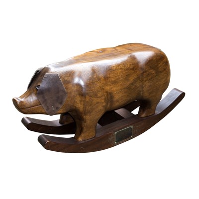 Lot 449 - A carved elm rocking pig with leather ears,...