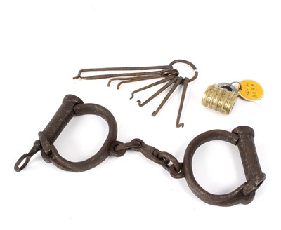 Lot 482 - A pair of 19th Century handcuffs, a set of...