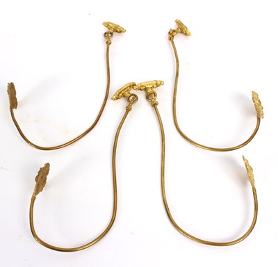 Lot 504 - Four gilt metal curtain tie-backs, each with...