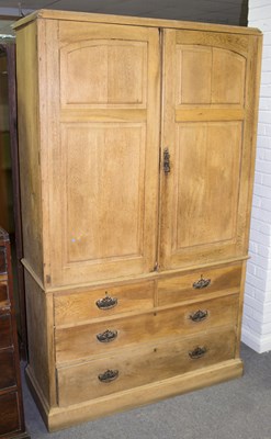 Lot 812 - An oak linen press enclosed by panelled doors...