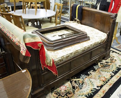 Lot 843 - A French Empire rosewood bed, one side...