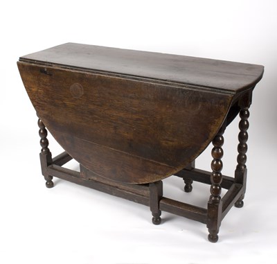 Lot 848 - A late 17th Century oak gateleg table on ball...