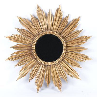 Lot 852 - A modern carved and gilded starburst mirror...