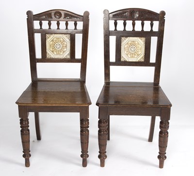 Lot 879 - A pair of Aesthetic movement oak hall chairs...