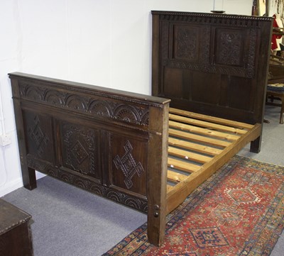 Lot 885 - A carved oak bedstead, the head board set...