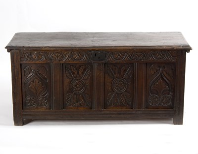 Lot 933 - A carved oak chest, with solid panel top,...