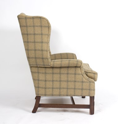 Lot 938 - A George III style wing armchair, upholstered...