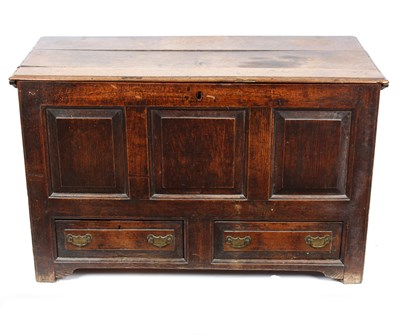 Lot 1003 - A George III oak mule chest, the fielded panel...