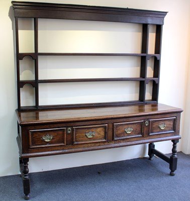 Lot 1006 - An oak dresser with associated shelves over...