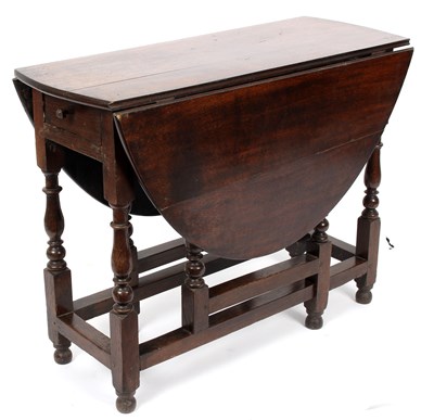 Lot 1008 - A 19th century oak gateleg table with frieze...