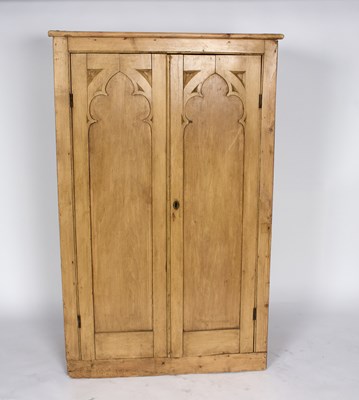 Lot 1016 - A pine cupboard enclosed by a pair of Gothic...