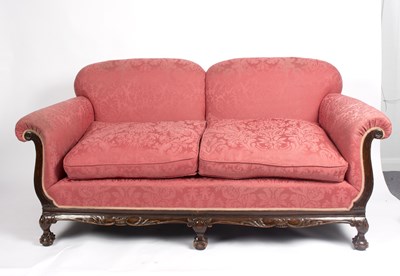 Lot 1021 - An upholstered two-seater sofa on ball and...