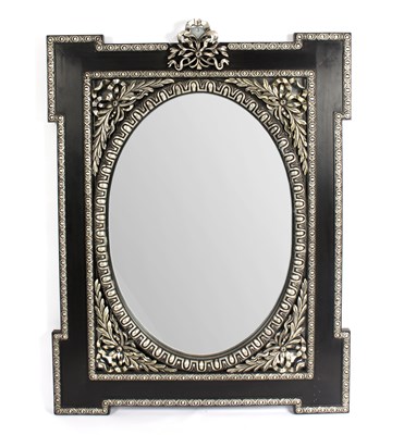 Lot 1026 - A silvered and ebonised wall mirror, the oval...