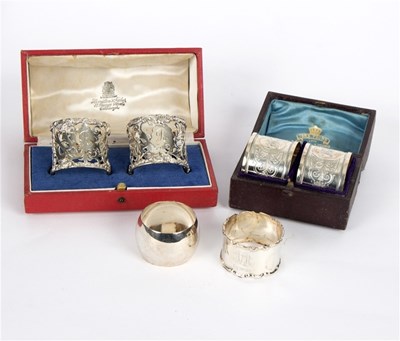 Lot 16 - Two pairs of cased silver napkin rings, and...