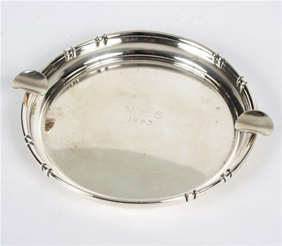 Lot 25 - A Cartier silver ashtray with faux bamboo rim,...