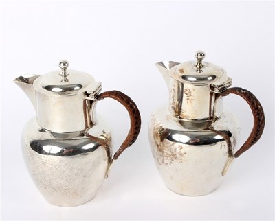 Lot 28 - A pair of silver lidded jugs, John Thomas...