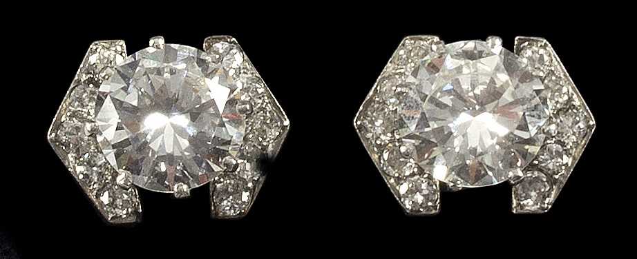 Lot 95 - A pair of diamond ear studs, each with central...