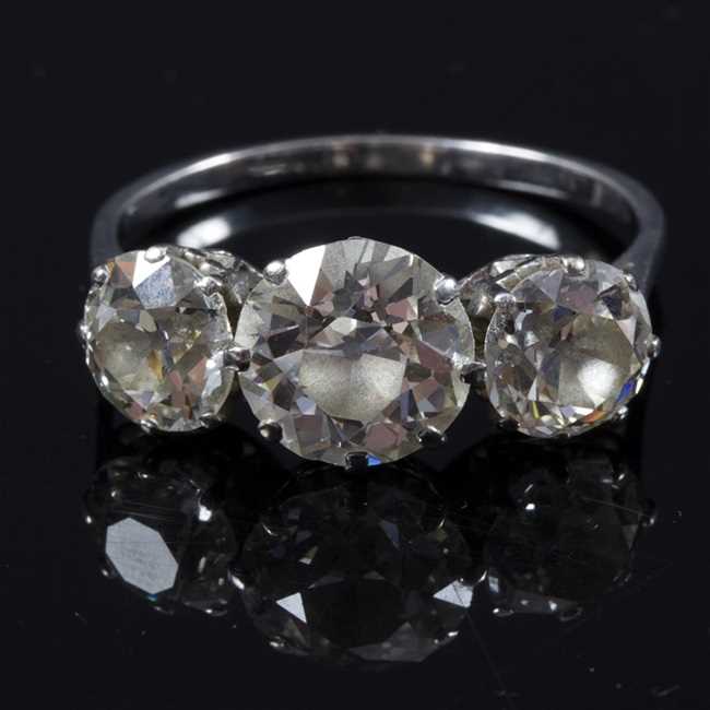 Lot 163 - A diamond three-stone ring, the central stone...