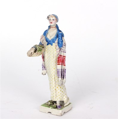 Lot 375 - A Chelsea Cheyne figure of a lady with flower...