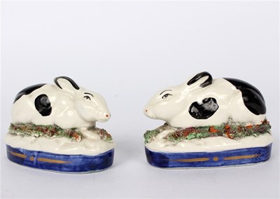 Lot 400 - Two Staffordshire pottery models of rabbits,...