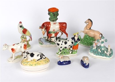 Lot 405 - Nine Staffordshire pottery models of animals...