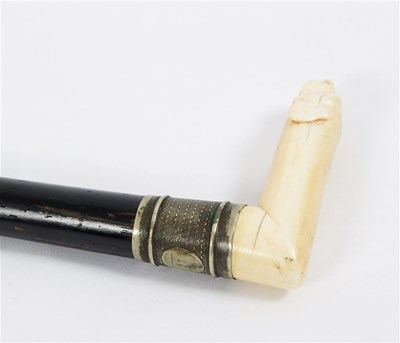 Lot 478 - An ebonised walking stick, the carved ivory...