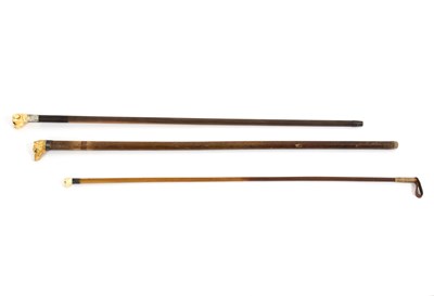 Lot 480 - A riding crop with a carved ivory handle in...