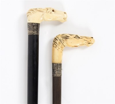 Lot 485 - Two ebonised walking sticks with carved ivory...