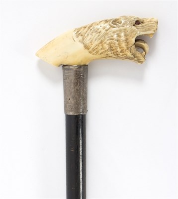 Lot 487 - An ebonised walking stick, the carved ivory...