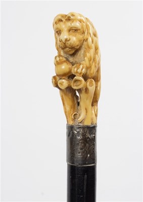 Lot 488 - An ebonised walking stick, the carved ivory...