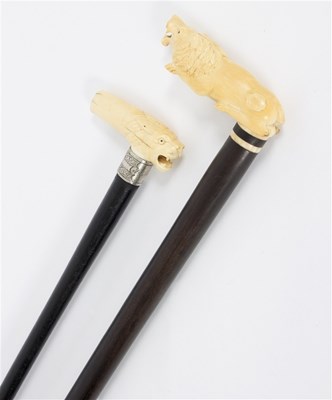 Lot 489 - Two ebonised walking sticks, the carved ivory...