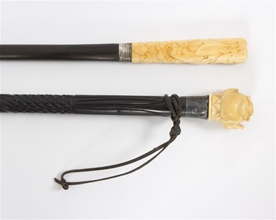 Lot 491 - An ebonised walking stick, the carved ivory...