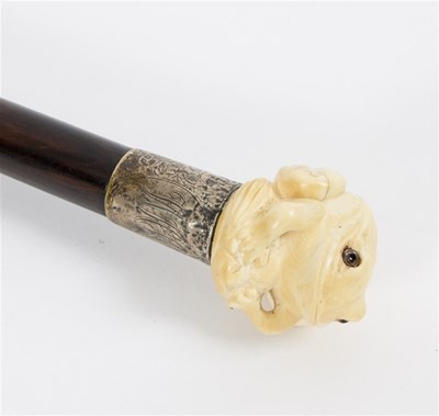 Lot 492 - An ebonised walking stick, the carved ivory...