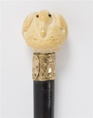 Lot 493 - An ebonised walking stick, the carved ivory...